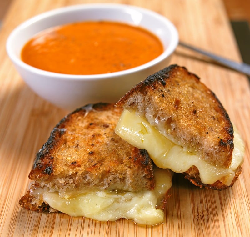 Gooey Grilled Cheddar Cheese Sandwich on Rye with Tomato Bisque on Bamboo Tabletop Food Picture