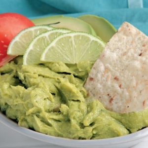 Guacamole in White Dish with Garnish and Chip Food Picture
