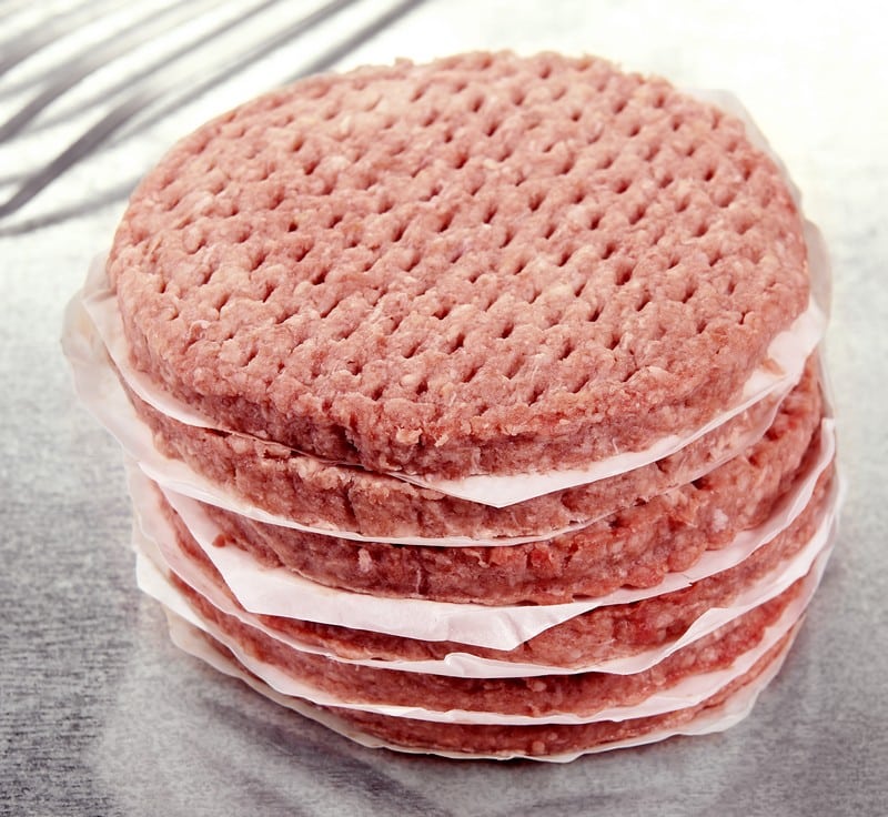 Stack of Freshly Ground Raw Beef Burger Patties on Brushed Aluminum Countertop Food Picture
