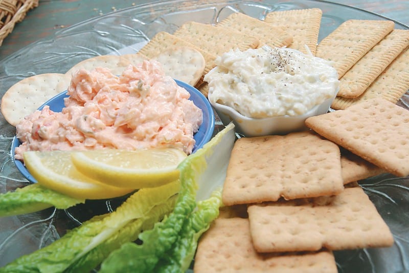 Imitation Crab Spread on a Plate with Crackers and Lemon Slices Food Picture