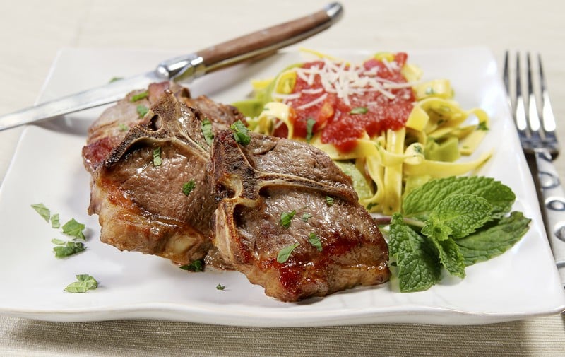 Cooked Lamb Chops with Mint Garnish and a Side of Pasta Food Picture