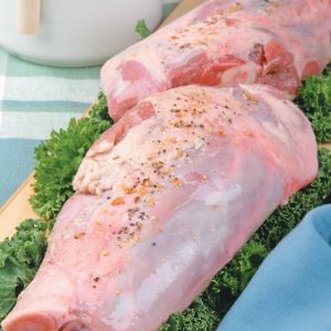 Raw Bone-In Lamb Leg Shank Seasoned on Bed of Garnish Food Picture