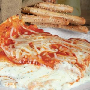 Lasagna with Breadsticks on a Plate Food Picture