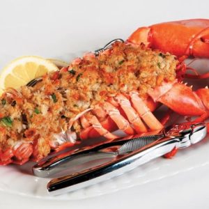 Baked stuffed lobster with cracker on white plate with light gray background Food Picture