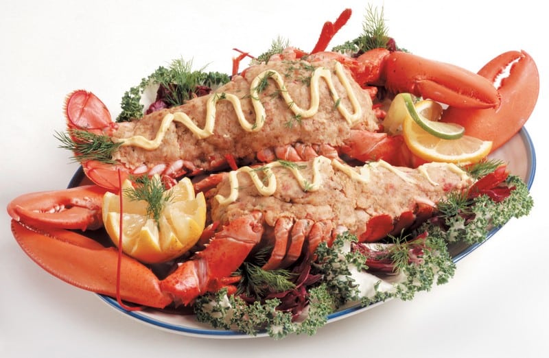 Baked stuffed lobster with garnish on serving plate Food Picture