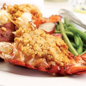 Baked stuffed lobster tail meal on white plate up-close Food Picture