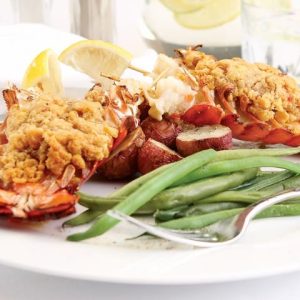 Baked stuffed lobster tail with green beans on white plate with fork Food Picture