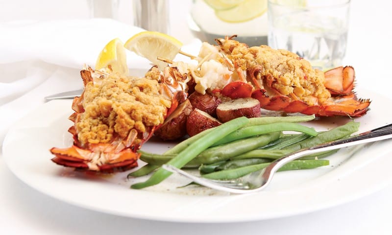 Baked stuffed lobster tail with green beans on white plate with fork Food Picture