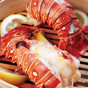 Steamed lobster tail with lemon in wooden steamer box Food Picture