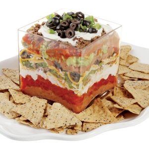 Mexican Seven Layer Dip in Clear Dish with Chips on White Plate Food Picture