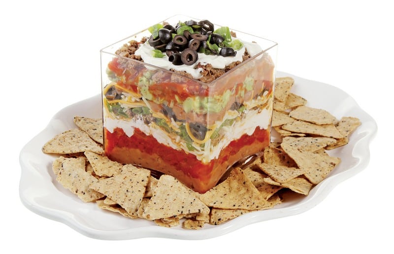 Mexican Seven Layer Dip in Clear Dish with Chips on White Plate Food Picture