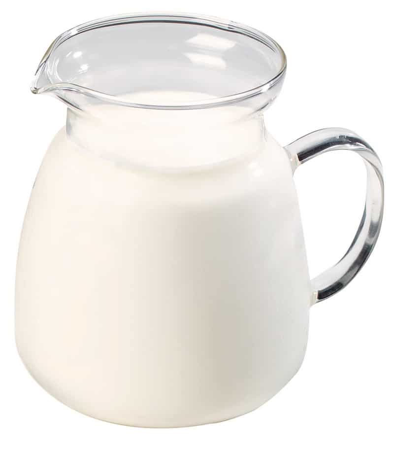 Pitcher of Milk in Clear Pitcher on White Background Food Picture