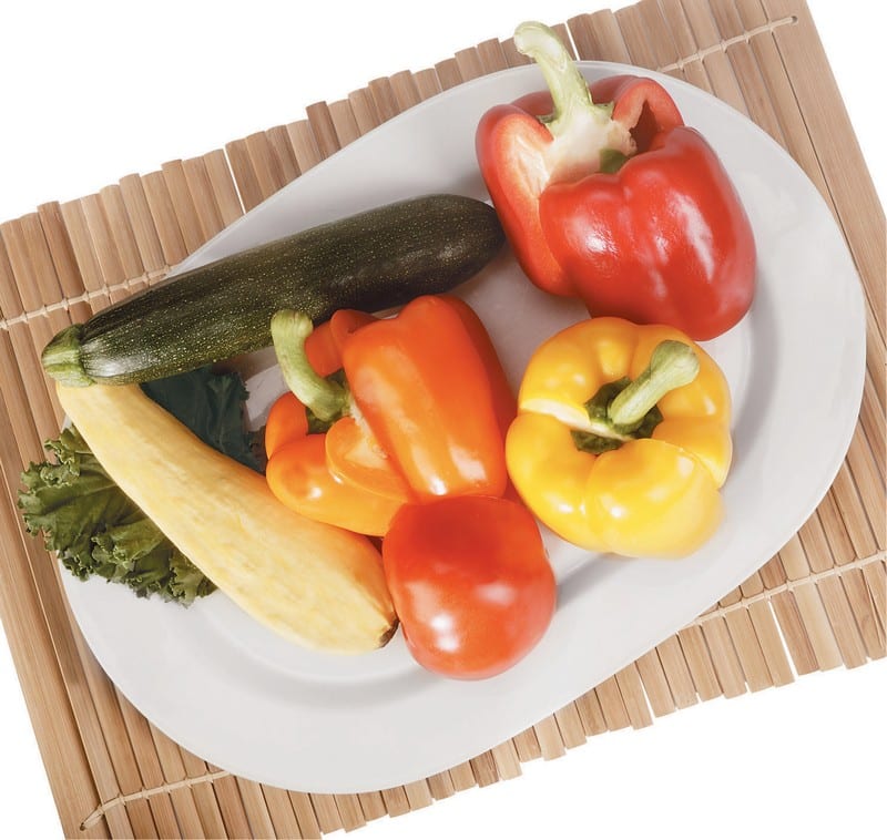 Mixed Whole Vegetables on a Plate with Mat Underneath Food Picture