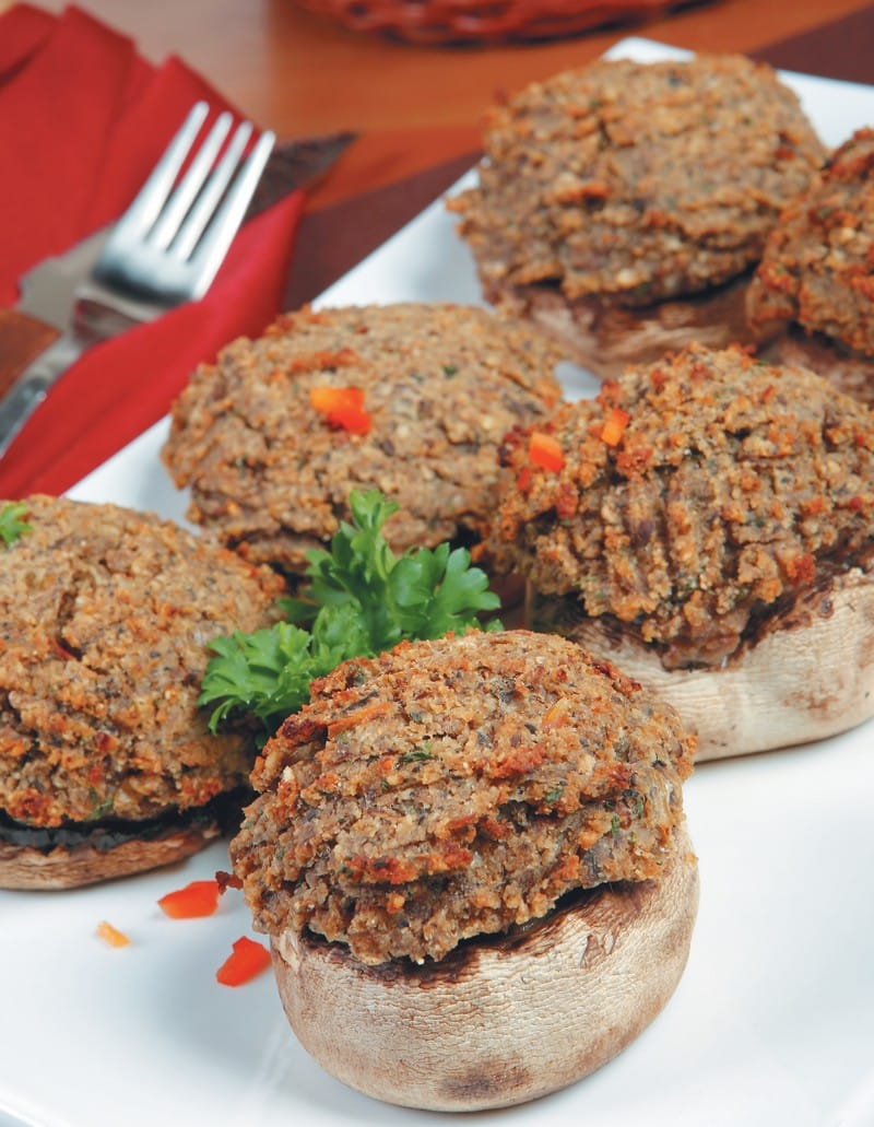 Stuffed mushrooms on white plate with red napkin on table Food Picture
