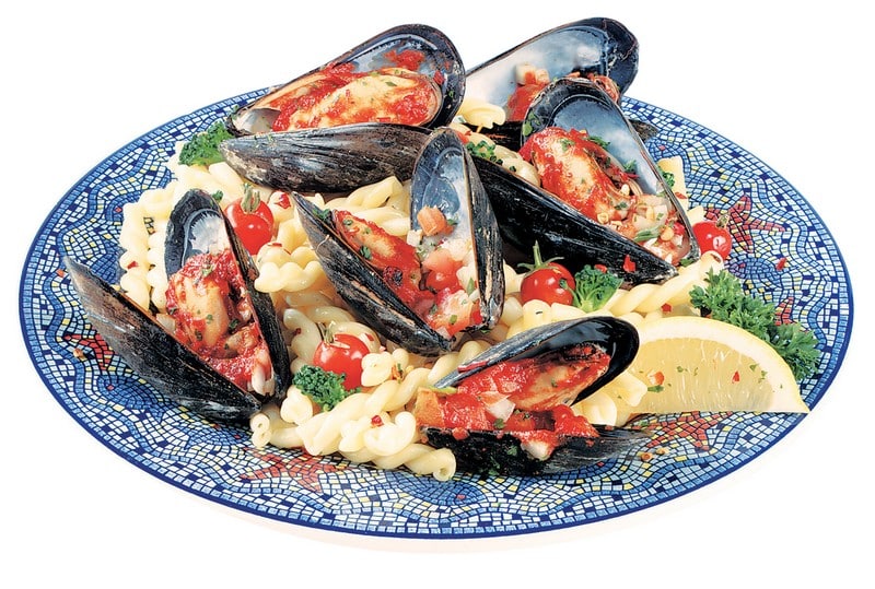 Mussels over Pasta with Garnish and Lemon on Decorative Plate Food Picture