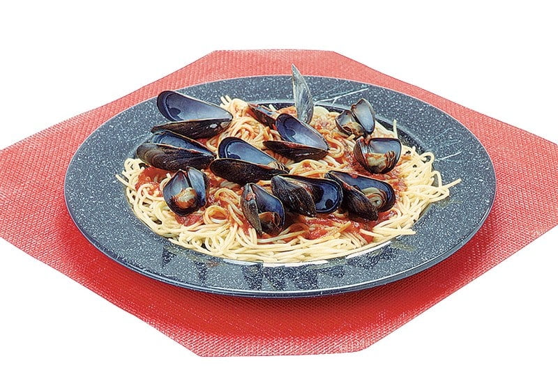 Mussels over Pasta in Black Dish on Red Placemat Food Picture
