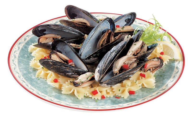 Mussels over Bowtie Pasta with Garnish on Plate Food Picture