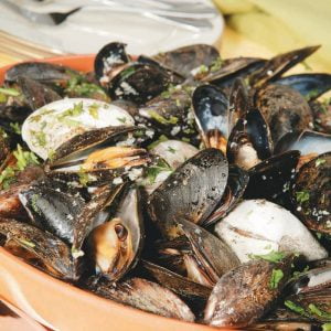 Bianco Mussels on Platter with a Spoon Food Picture