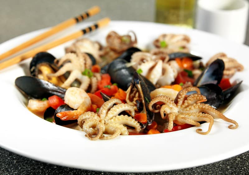 Cooked Octopus, Scallops and Mussels with Vegetables in White Ceramic Bowl Food Picture