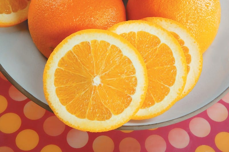 Fresh Whole and Sliced Oranges on Plate Food Picture