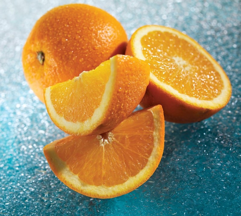 Fresh Whole, Halved and Wedged Navel Oranges Food Picture