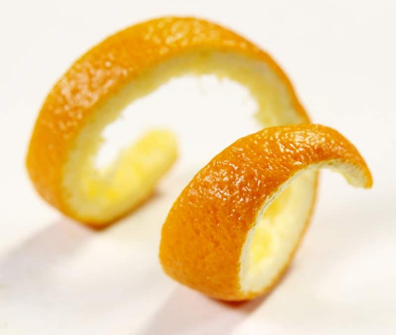 Fresh Zested Orange Twist on Matte Slate Countertop Food Picture
