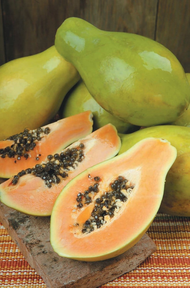 Papayas and Papaya Slices on a Block Food Picture
