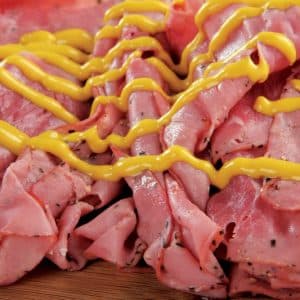 Sliced Pastrami with Mustard on Wooden Surface Food Picture