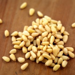 Fresh Pine Pignoli Nuts on Walnut Tabletop Food Picture
