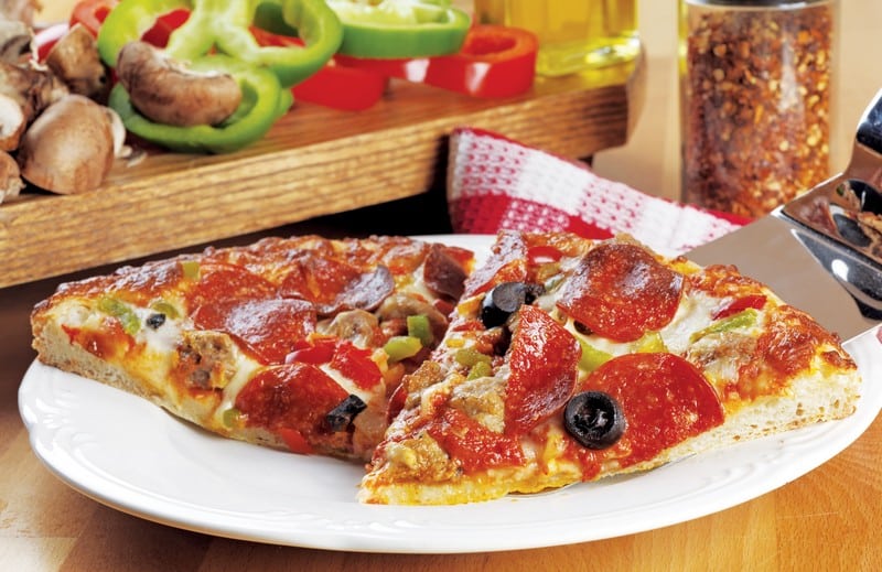 Sliced Pizza with Toppings on White Plate Food Picture