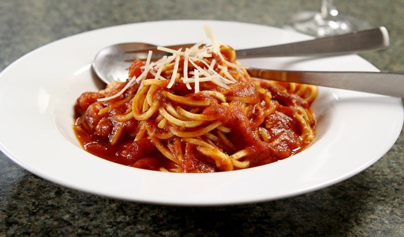Spaghetti with Marinara Sauce and Parmesan Cheese in White Ceramic Bowl on Granite Countertop Food Picture