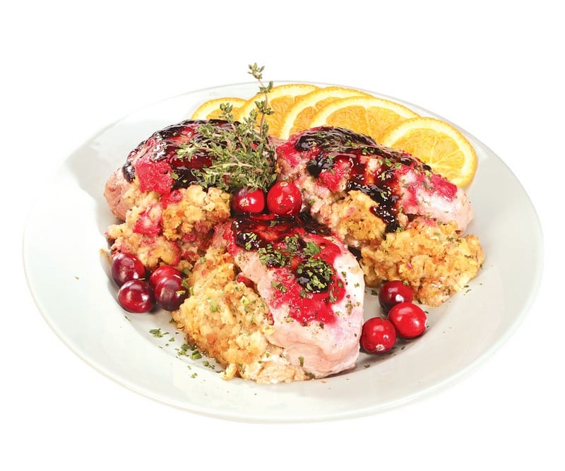 Stuffed Boneless Pork Chops on a Plate with Lemon Slices Food Picture