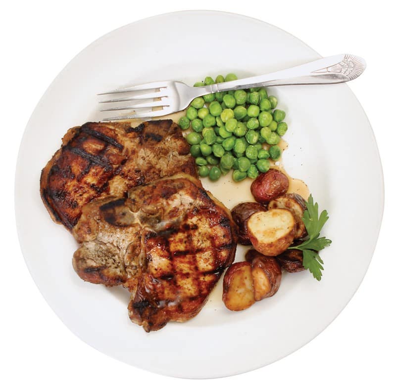 Pork Chops with Grill Marks on a Plate with Peas Food Picture