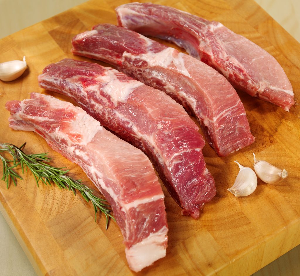 Sliced Raw Country Style Pork Ribs on Cutting Board Food Picture