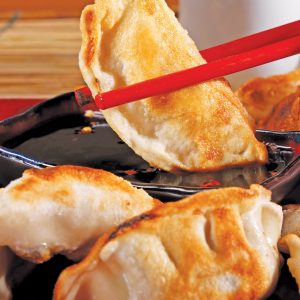 Pan Fried Potsticker's with Red Chopsticks Food Picture