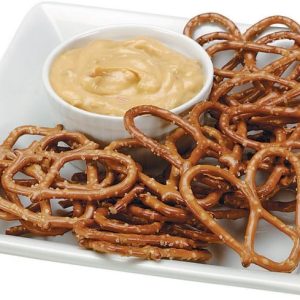 Thin Pretzels on a Plate with Cheese Dip Food Picture