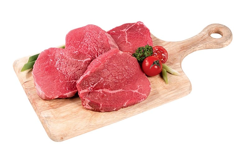 Raw Beef Eye Round Steak on a Wooden Board with Tomatoes Food Picture