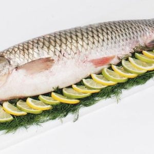 Whole Raw Carp over Greens and Lemons Food Picture