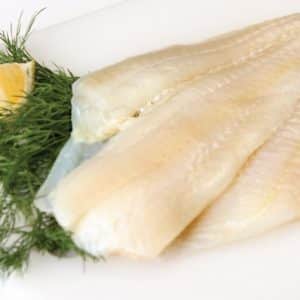 Raw Flounder Fillet with Garnish on White Surface Food Picture