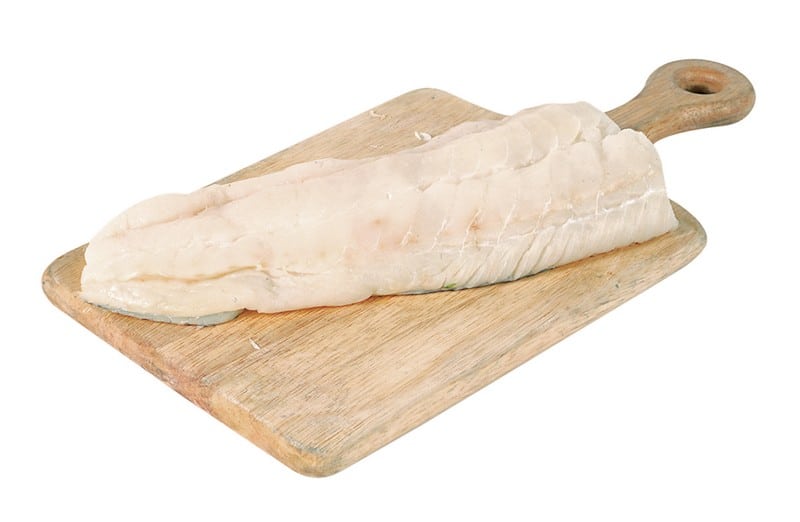 Haddock fillet on wooden slab with white background Food Picture