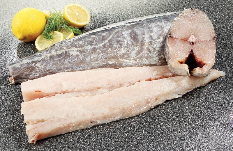 Whole Raw King Fish with Garnish on Countertop Food Picture