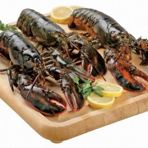 Lobster on wooden slab with garnish Food Picture