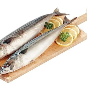Whole Mackerel on wooden slab with garnish Food Picture