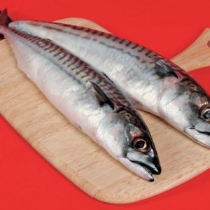 Whole Mackerel fish on wooden slab with red background Food Picture