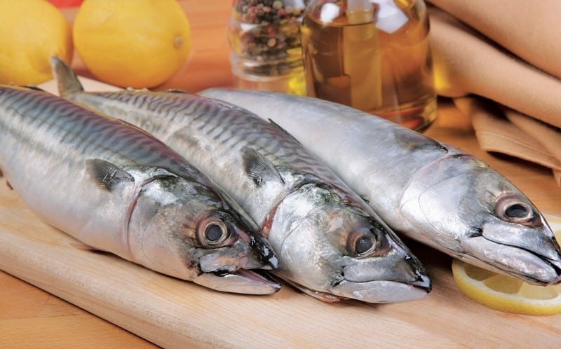 Whole Mackerel on wooden slab with lemon Food Picture