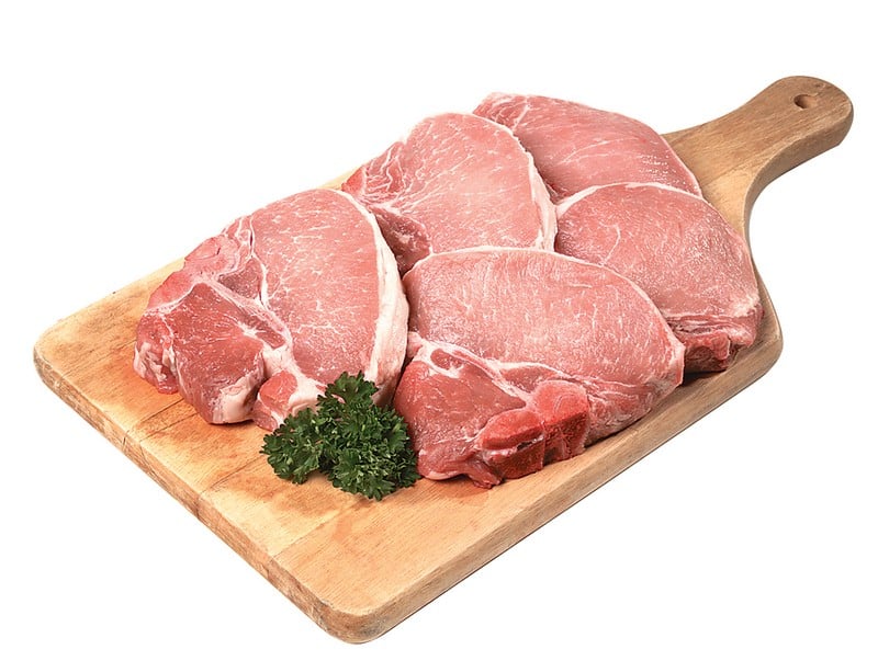Fresh Raw Bone-In Pork Chops on Cutting Board Food Picture