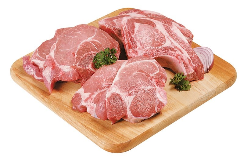 Fresh Assorted Raw Bone-In Pork Chops on Cutting Board Food Picture
