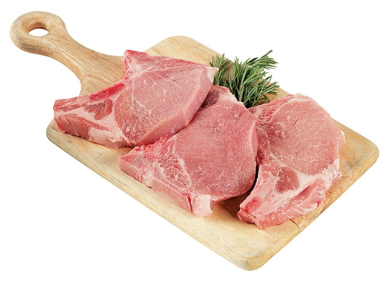Fresh Raw Bone-In Center Cut Pork Chops on Cutting Board Food Picture