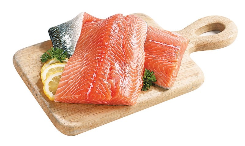 Atlantic salmon fillet on wooden board with garnish on white background Food Picture