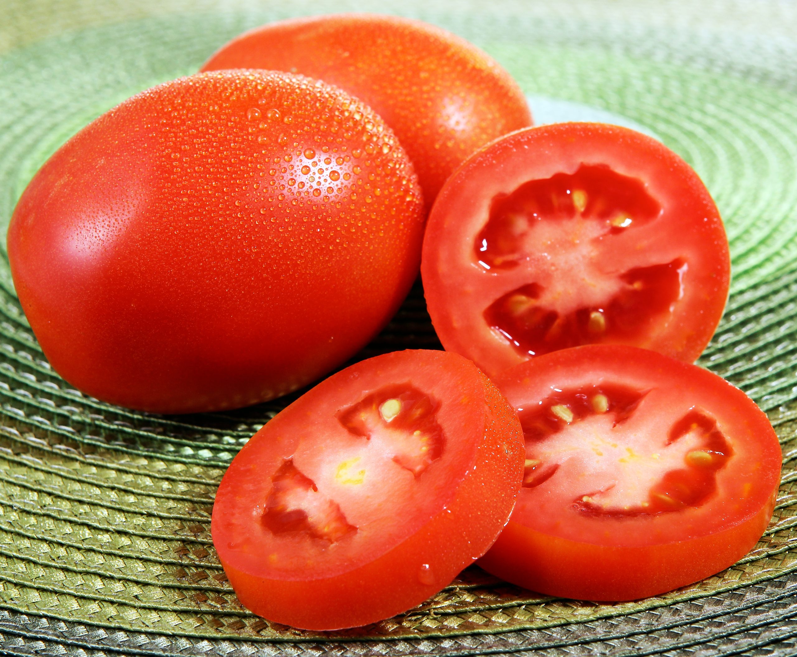 Sliced & Whole Roma Tomatoes on Table Food Picture